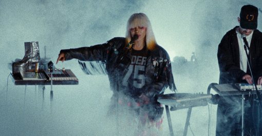 Erykah Badu and The Alchemist performing in a smoky courtyard directed by Yasser Abubeker